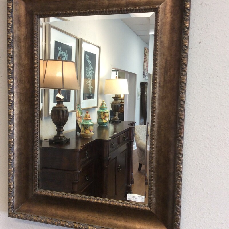 This elegant mirror from Uttermost has a beautiful, oversized, antiqued bronze, gilted frame. Can be hung vertical or horizontal