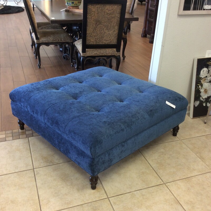 This is a custom-made, extra large ottoman. Upholstered in a brilliant blue with button-tufting.