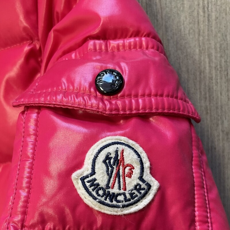Moncler Bady Down Jacket, Fuchsia, Size: 8Y<br />
Moncler Bady Down Jacket, Fuchsia, Size: 8Y<br />
<br />
Great Condition - Small pull in back<br />
<br />
A tribute to the mountains, the Bady short down jacket for girls is studied to deliver high-performance even on the coldest days of winter. The warm puffer jacket boasts the iconic Moncler design, reinterpreted for children.<br />
DETAILS<br />
<br />
Crafted from nylon laqué<br />
Nylon laqué lining<br />
Down-filled<br />
Detachable hood<br />
Zipper closure<br />
Zipped pockets<br />
Flap patch pocket on sleeve<br />
Elastic cuffs