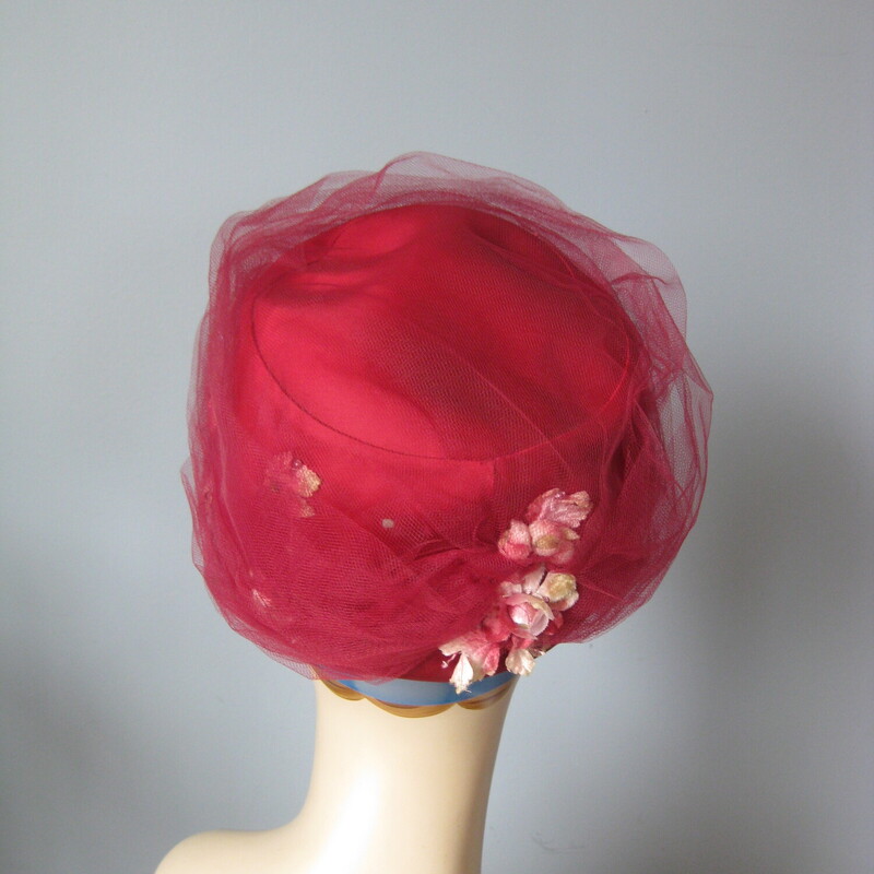 Vtg Mesh Flower, Burgundy, Size: None<br />
Dreamy pillbox hat from the 50s<br />
This hat is a structured pill box generously covered with with same color netting.  Peeking from out from the netting are pale color fabric flowers.<br />
<br />
The main color is deep deep pink almost burgundy red.<br />
Union label<br />
Interior circumference: 21 7/8<br />
My  mannequin has a smaller than average head so this hat may sit higher or further back on the crown of your head.<br />
thanks for looking!<br />
<br />
#63062