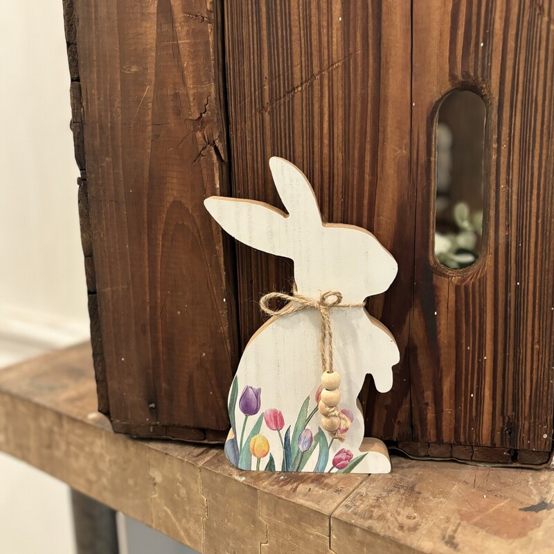 The Tulip Bunny is an adorable addiition to your spring and Easter decor. The bunny is painted a distressed white and has colorful tulips with a jute rope and beads tied around his neck. This bunny measures 8 inches high by 4.5 inches wide and .75 in deep