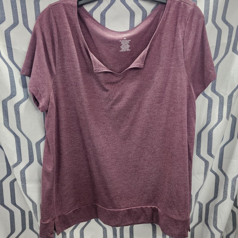 Short sleeve tee in a light burgandy color. Has a v neck line that has drooping lapels. Banded at the waist.