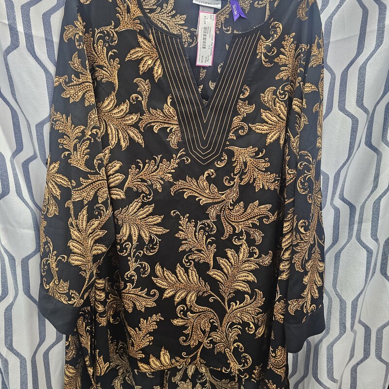 Three quarter sleeve blouse with tabs that can be used to cuff sleeves. This blouse is black with gold graphic print and gold embroidered neckline. So cute!