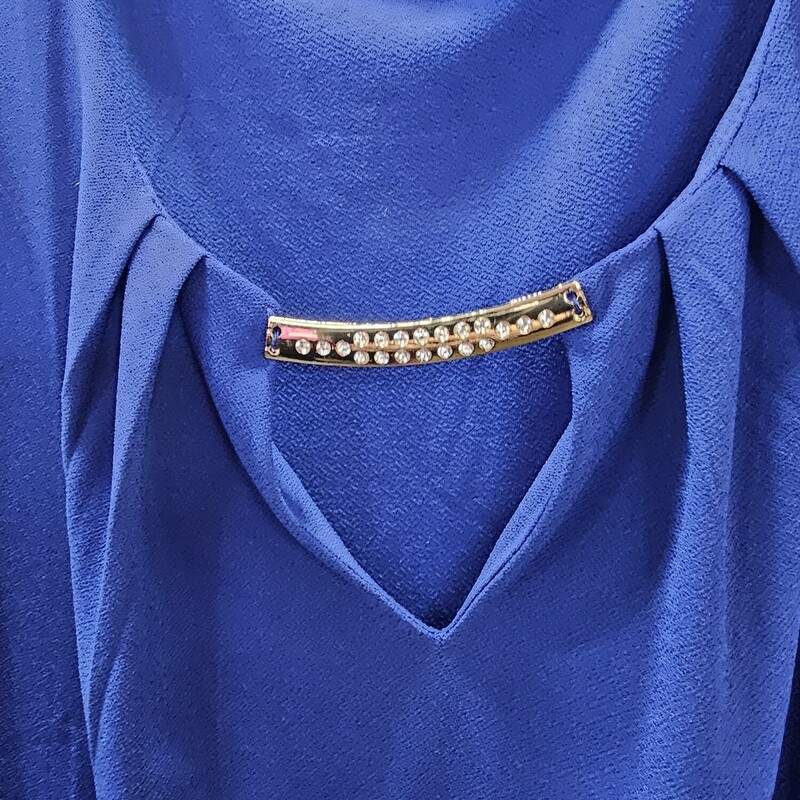 Cute blue blouse with short sleeves and touch of gold and rhinestone bling at the neckline in a very classy fashion.