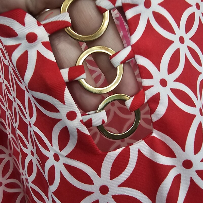 Short sleeve blouse in a red and white fun pattern with bronze mettallic gold rings at the neck line.