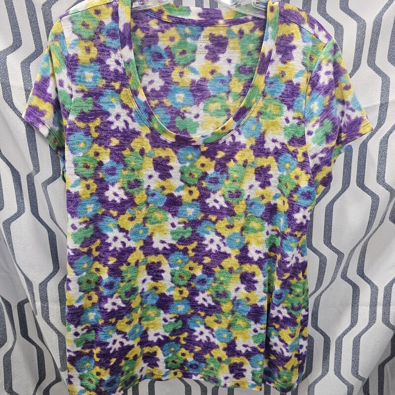 Love this super cute and soft tee in a fun floral print and a scoop neckline. Yellow, blue, green purple and white never looked so good together. Great with your favorite denim capris.