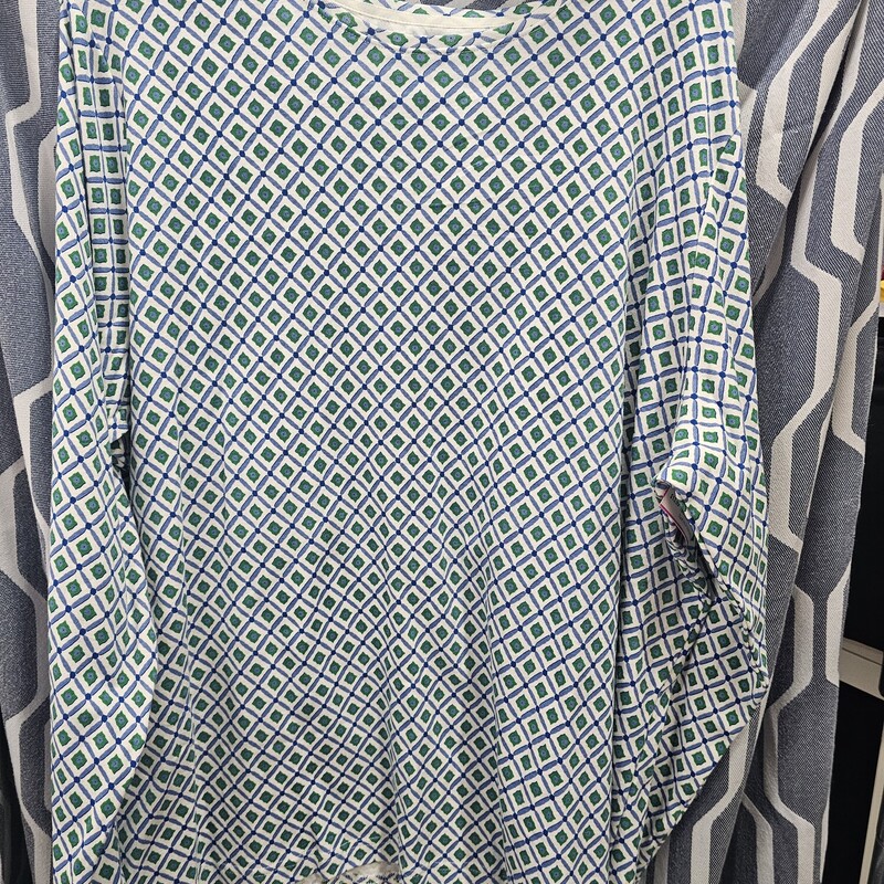 Long sleeve knit top in white with blue and green fun pattern. Crew neckline.