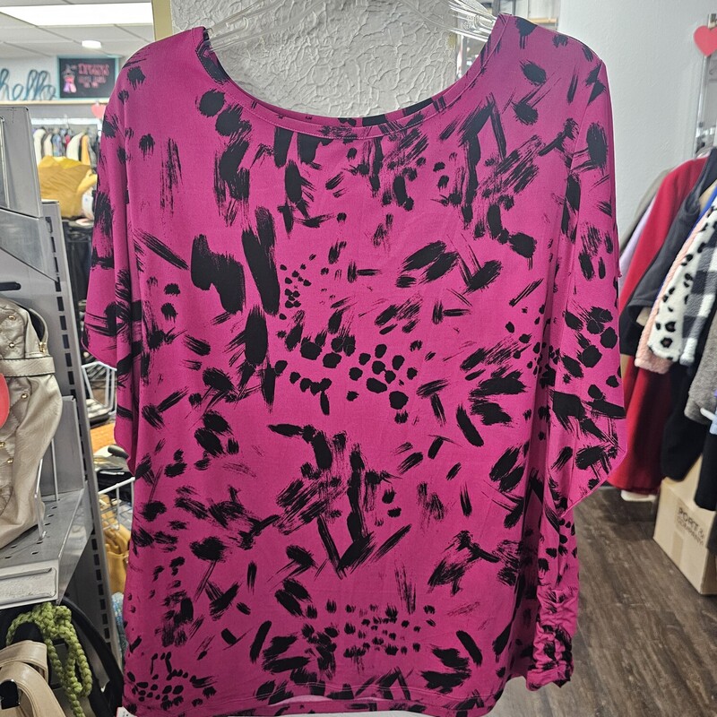 Super cute blouse with short ruffle sleeves in a black and pink/muted magenta print. Super cute under a blazer or with your favorite jeans for a night out.
