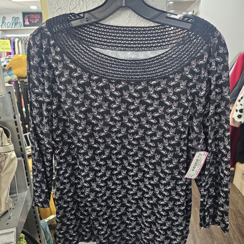 Half sleeve knit top in black with white and pink butterfly print. Collar done in a mesh lace like finish.