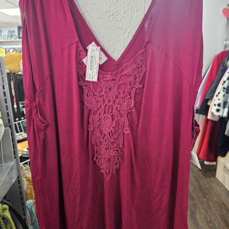 Super cute burgandy knit top with cap style sleeves and an embellished front chest piece.  Brand new with the tags.