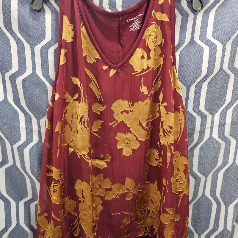Cute burgandy tank that is knit with a sheer overlay on the front that is adorned with mustard yellow floral design.