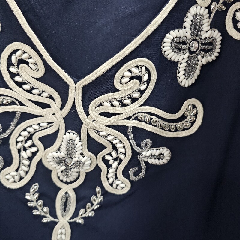 Long sleeve blouse in navy blue that id one with embroidering and beadwork, Complete with sheer bell sleeves.
