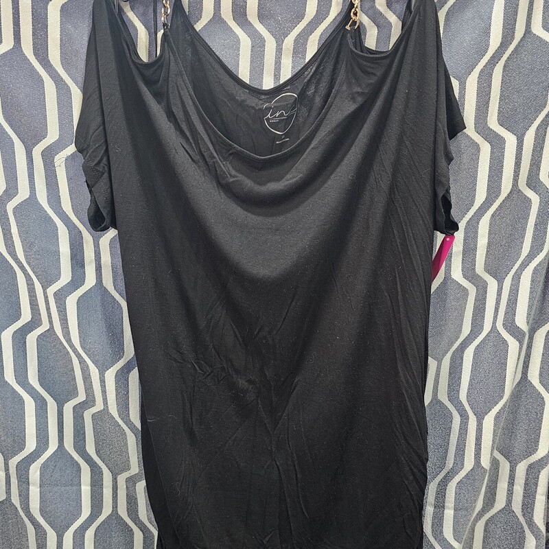 This short sleeve cold shoulder knit top is done in black with straps made of gold chains. Super chic