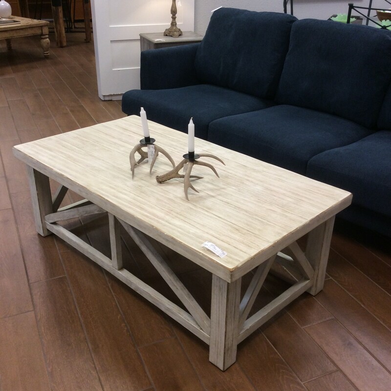 This is a lovely painted coffee table. Farmhouse in style, it's been painted and distressed for that weathered, timeless look.