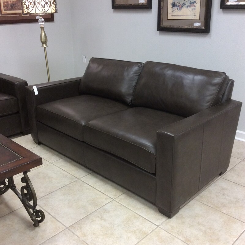 Gorgeous! This loveseat from Ethan Allen Furniture is Sumptuous! Upholstered in a dark sable, soft as butter leather. It features cool, clean lines. It's beauty is in it's simplicity. There is also a matching sofa priced separately. Come take a look, it won't be here long!