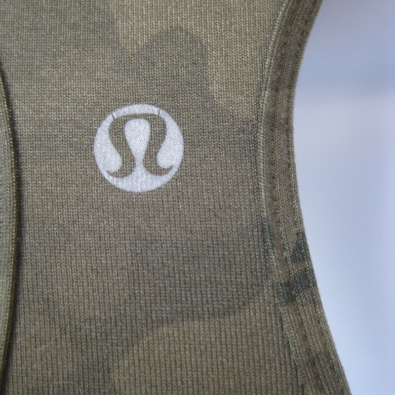 Lululemon Camo Workout, Green, Size: Small<br />
<br />
Lululemon matching set in green camo<br />
Racerback tank<br />
capri leggings with wide waist band, there is a slot pocket accessible from the top of the waist band that will hold a key or a card.<br />
<br />
Flat measurements: these measurements were taken with the garments lying flat and not stretched<br />
top: armpit to armpit: 15<br />
       length: 22.75<br />
Pants: Waist: 14 1/8<br />
            hip: 18<br />
             inseam: 20.5<br />
            rise: 8.5<br />
<br />
Excellent condition!<br />
#66987