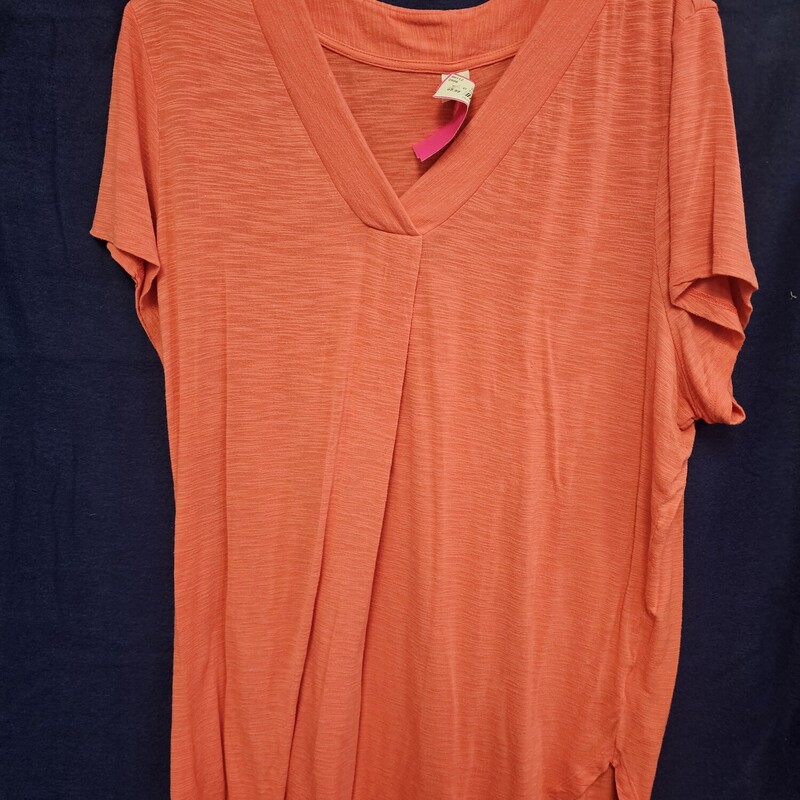 Short sleeve knit top with v neckline in a salmony pink.