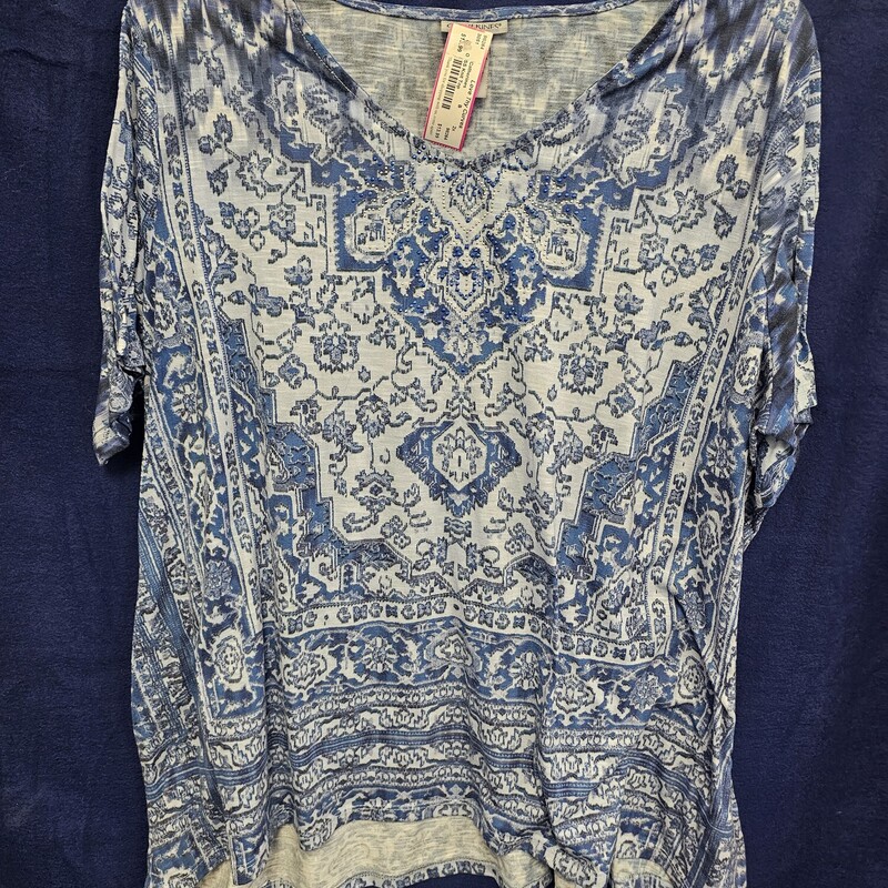 Cute short sleeve knit top in blue with fun blue pattern and silver metallic studding on the chest.