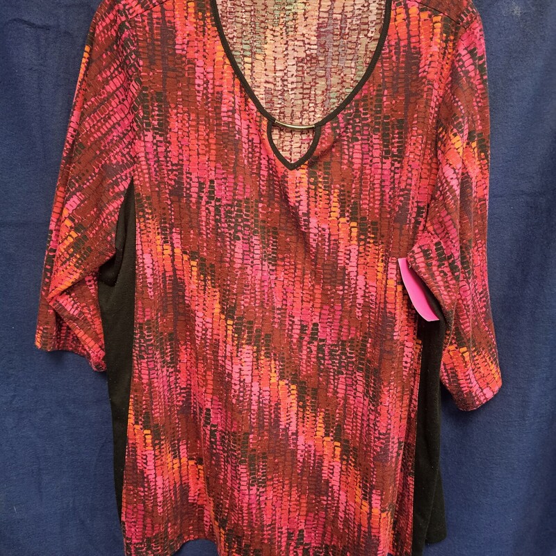 Half sleeve knit top in a fun pink, orange and burgandy pattern with metallic embelishment along front neckline.