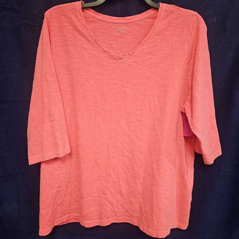 Half sleeve knit top in a neon orange/pink color.