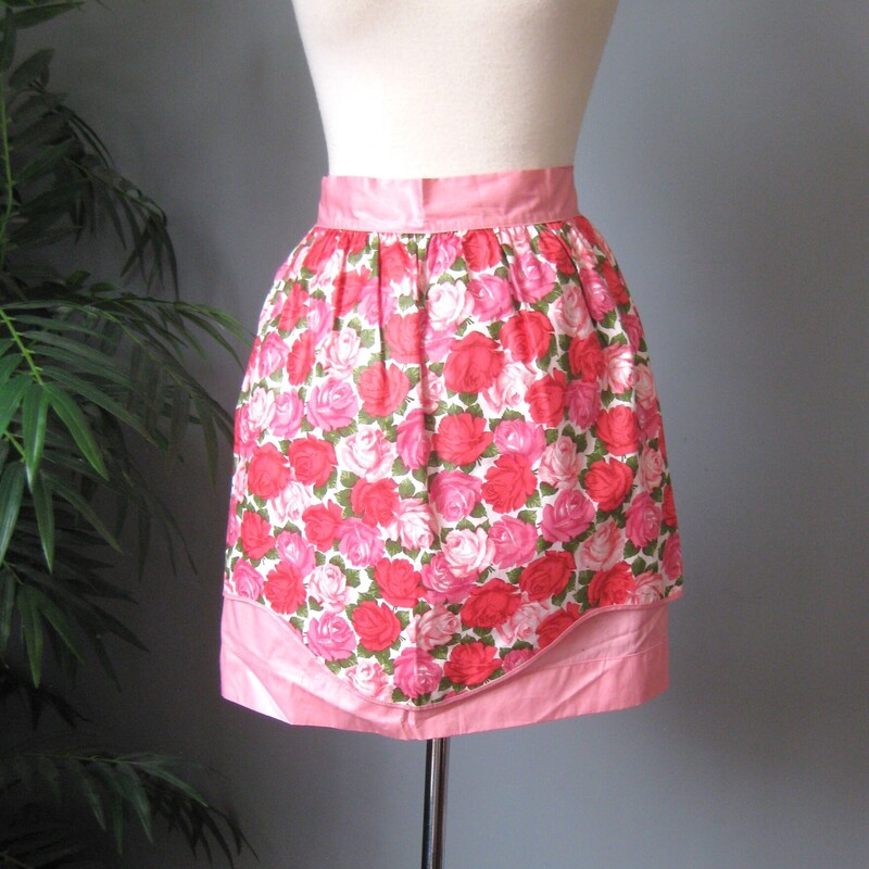 Vtg Floral Apron, Pink, Size: None<br />
Cute apron handmade from 1970s floral cotton fabric.<br />
It's a half apron with white lace trim and a big pocket<br />
The white lace is stretchy.<br />
The waist band measures 18 (not including the ties).<br />
total length from end to end is 57<br />
Excellent condition!  No stains or tears<br />
Thanks for looking!<br />
#66305