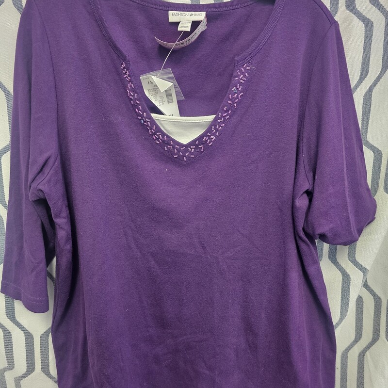 Brand new with tags, half sleeve knit top in purple with white sewn in shell panel and beading along the v neck