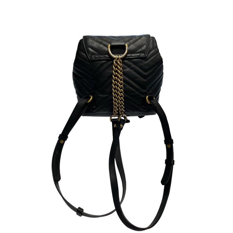 Gucci Marmont Black Backpack<br />
<br />
Size Mini<br />
Dimensions:<br />
Width (at base): 7.5<br />
Height: 7.5<br />
Depth: 3.5<br />
Shoulder Strap Drop: Adjustable, 14<br />
<br />
This backpack is crafted of chevron-quilted calfskin leather in black. The backpack features adjustable shoulder straps, and an aged gold GG Marmont logo on the front. The front flap opens to a leather cinch cord, and beige microfiber interior with a patch pocket.<br />
<br />
Some minor wear on leather<br />
Some marks in the interior<br />
Some minor discoloration of hardware
