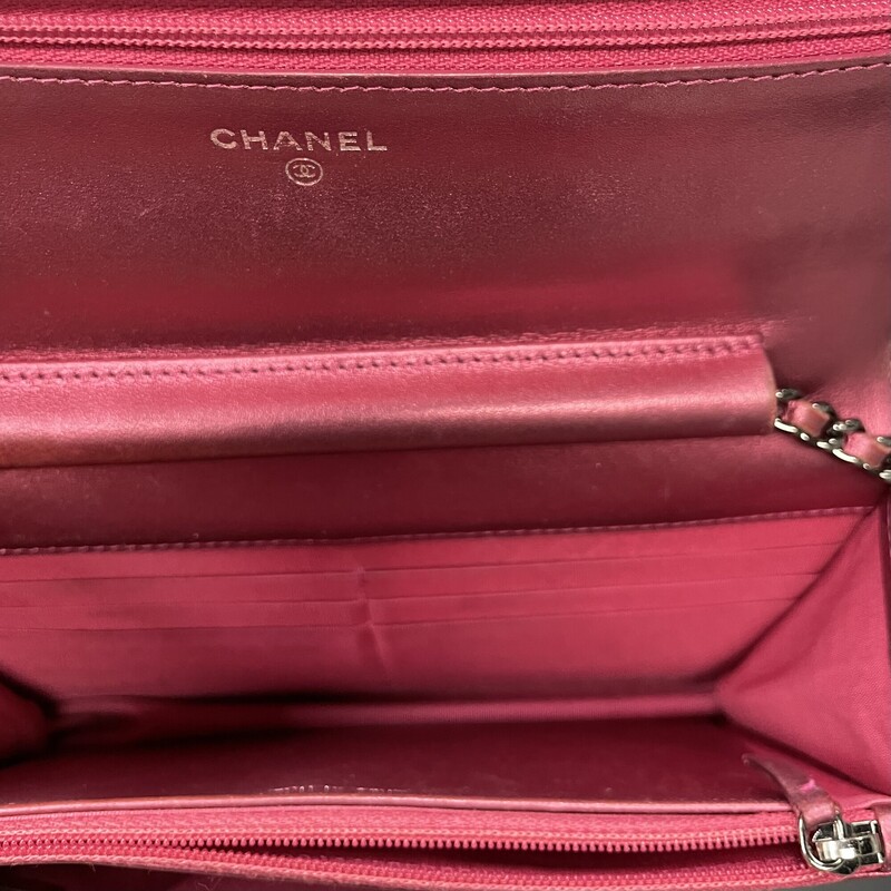 Chanel  Boy Metallic, Pink, WOC<br />
<br />
Chanel Boy Wallet on a Chain. Metallic hot pink/fuchsia patent leather.This wallet on a chain features a shiny ruthenium chain link leather threaded shoulder strap and a shiny ruthenium Boy Chanel CC lock on the flap, which closes with a press-stud.The interior is in hot-pink leather and material with a love-letter zip under the flap, a zip pocket, a concertina compartment, and 6 card slots<br />
<br />
Year: 2014<br />
Demensions:<br />
Length: 7.50 in<br />
Width: 1.25 in<br />
Height: 5.00 in<br />
Drop: 24.25 in