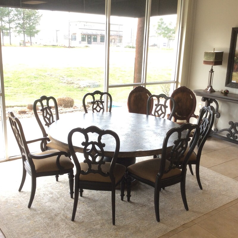 This is a stunning diningroom set!  The table features a large pedestal base. It has been painted distressed and has a bold scrollwok embellishment on the tabletop. Loads of character and persaonality. The set of 7 chairs are beautifully carved, the seats have been upholstered in a houndstooth pattern.