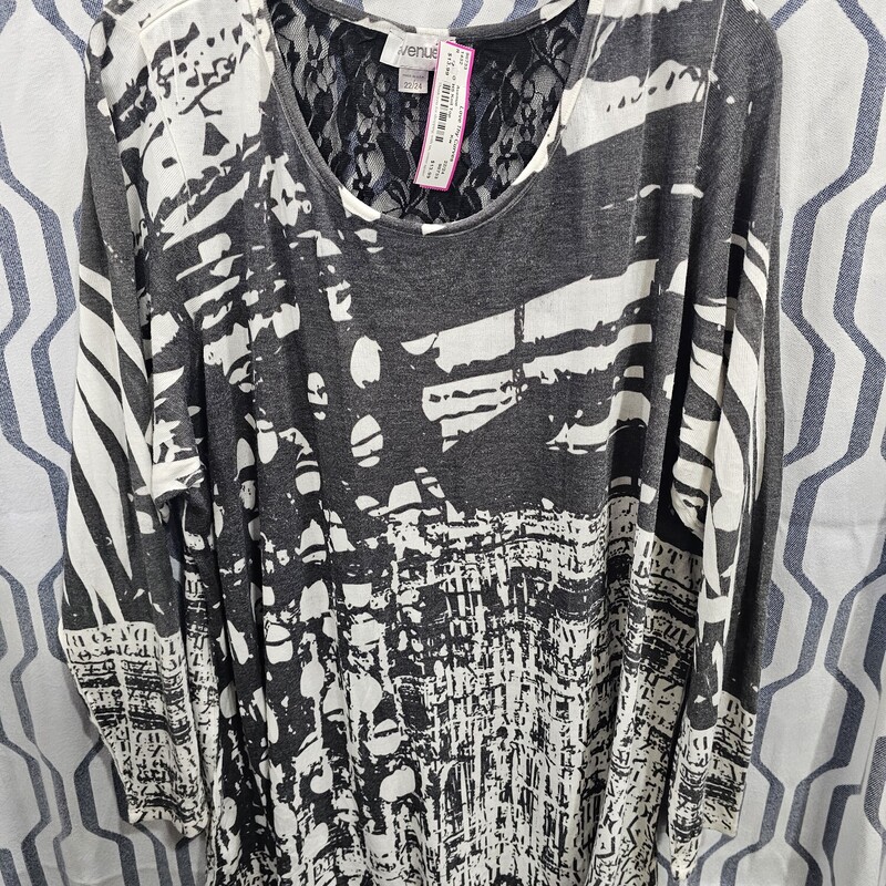 Half to three quarter sleeve knit top in black white and grey print with lace panel in back