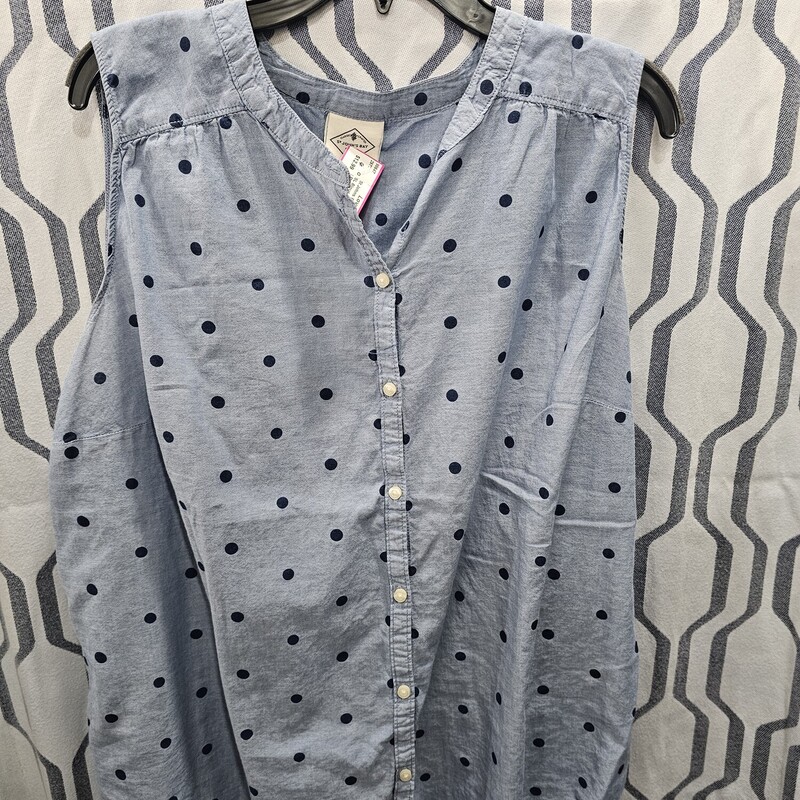 Sleeveless button up blouse in a denim blue with navy blue polka dots.