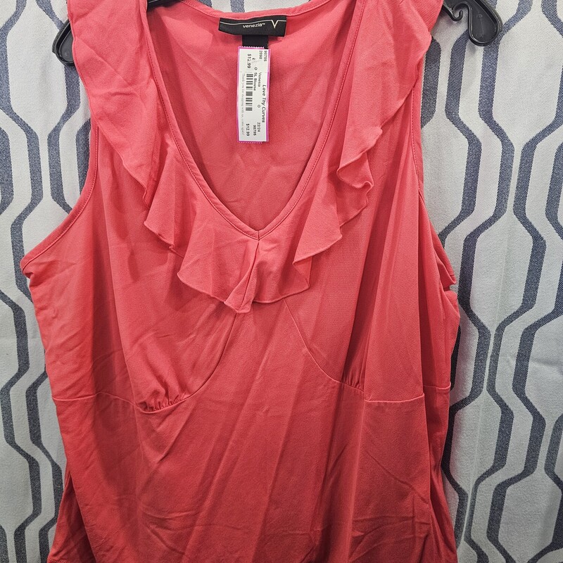 Sleeveless blouse with ruffle at the neckline in a pink orange color
