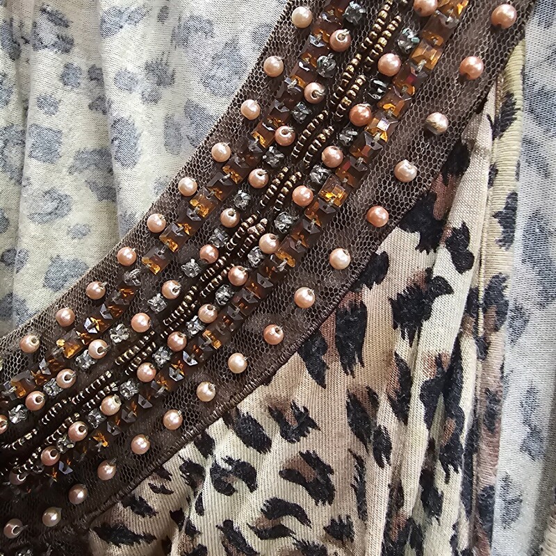 Black and brown animal print tank with sharkbite bottom and beading on the neck