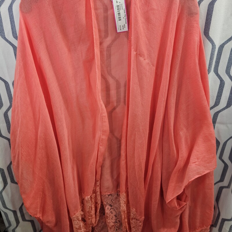 Beautiful kimono top that fits all sizes in peach with lace on the bottom.