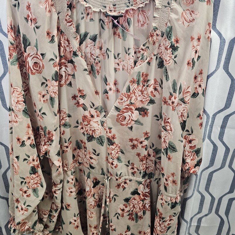 Long sleeve sheer blouse in a soft brown with floral print.
