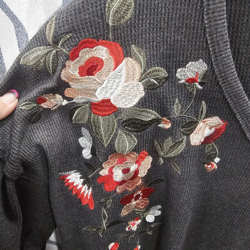 Cute long sleeve knit top in grey with embroidered floral design.