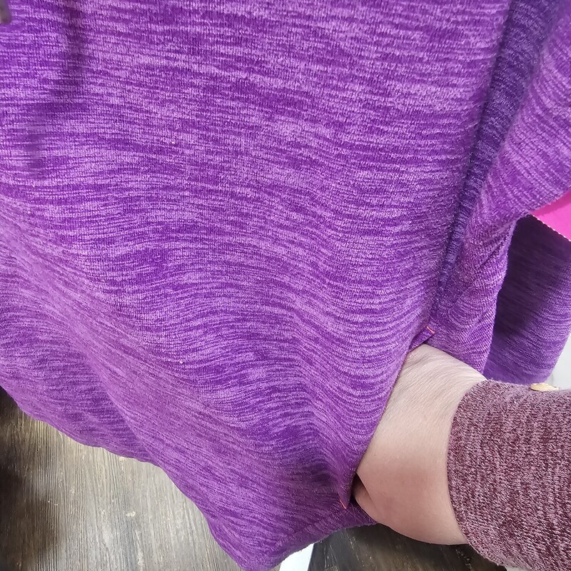Pull over style hoodie in purple with no pouch pocket but it does have two hand pockets and the thumb cut outs in the cuffs.