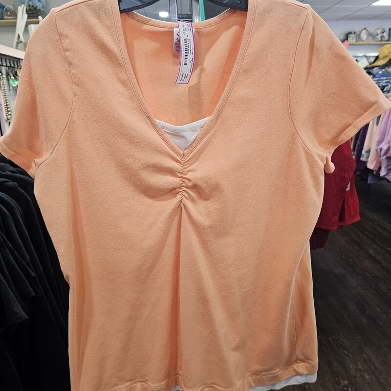 Short sleeve knit top in orange with sewn in tank panel in white.