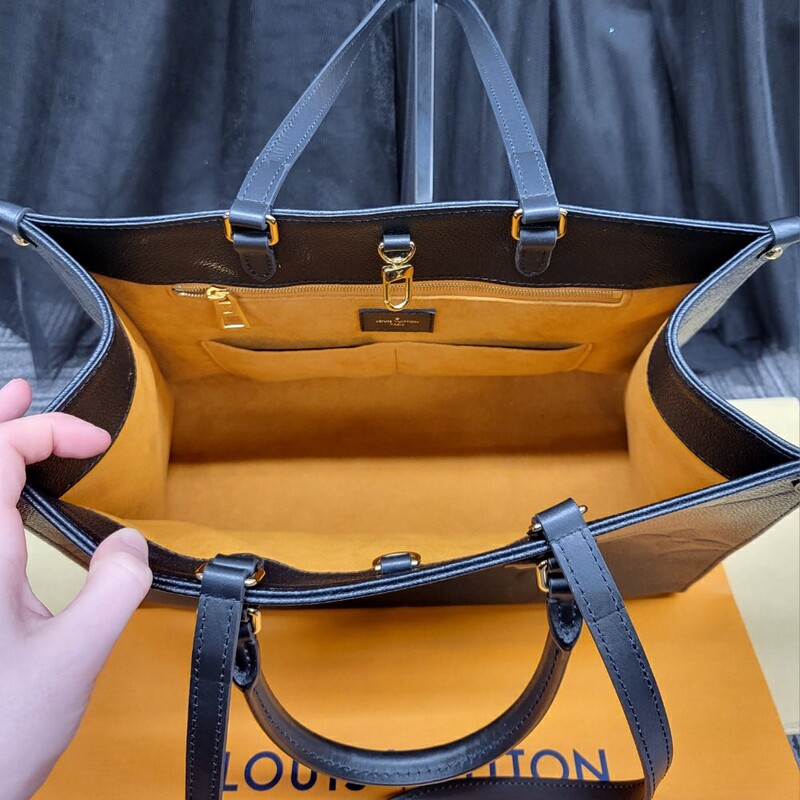 BRAND NEW CONDITION!!<br />
Comes with Duster and Receipt Dated 2022<br />
<br />
Still available on the website for $4350.00<br />
<br />
The OnTheGo MM tote is made from grained Monogram Empreinte cowhide leather, a soft leather that is embossed with a large Monogram pattern. Large enough for daily essentials, it features two sets of handles, short and long, for carry options. The inside zipped pocket and two inside flat pockets help keep things organized.<br />
<br />
13.8 x 10.6 x 5.5 inches<br />
(length x height x width )<br />
Black<br />
Monogram Empreinte embossed grained cowhide leather<br />
Grained cowhide-leather trim<br />
Microfiber gold lining<br />
Gold-color hardware<br />
Hook closure<br />
Inside flat zipped pocket<br />
Inside double pocket<br />
Handle:Double