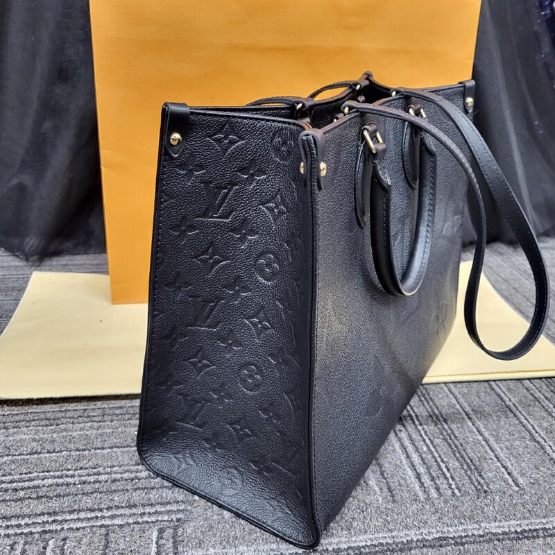 BRAND NEW CONDITION!!<br />
Comes with Duster and Receipt Dated 2022<br />
<br />
Still available on the website for $4350.00<br />
<br />
The OnTheGo MM tote is made from grained Monogram Empreinte cowhide leather, a soft leather that is embossed with a large Monogram pattern. Large enough for daily essentials, it features two sets of handles, short and long, for carry options. The inside zipped pocket and two inside flat pockets help keep things organized.<br />
<br />
13.8 x 10.6 x 5.5 inches<br />
(length x height x width )<br />
Black<br />
Monogram Empreinte embossed grained cowhide leather<br />
Grained cowhide-leather trim<br />
Microfiber gold lining<br />
Gold-color hardware<br />
Hook closure<br />
Inside flat zipped pocket<br />
Inside double pocket<br />
Handle:Double