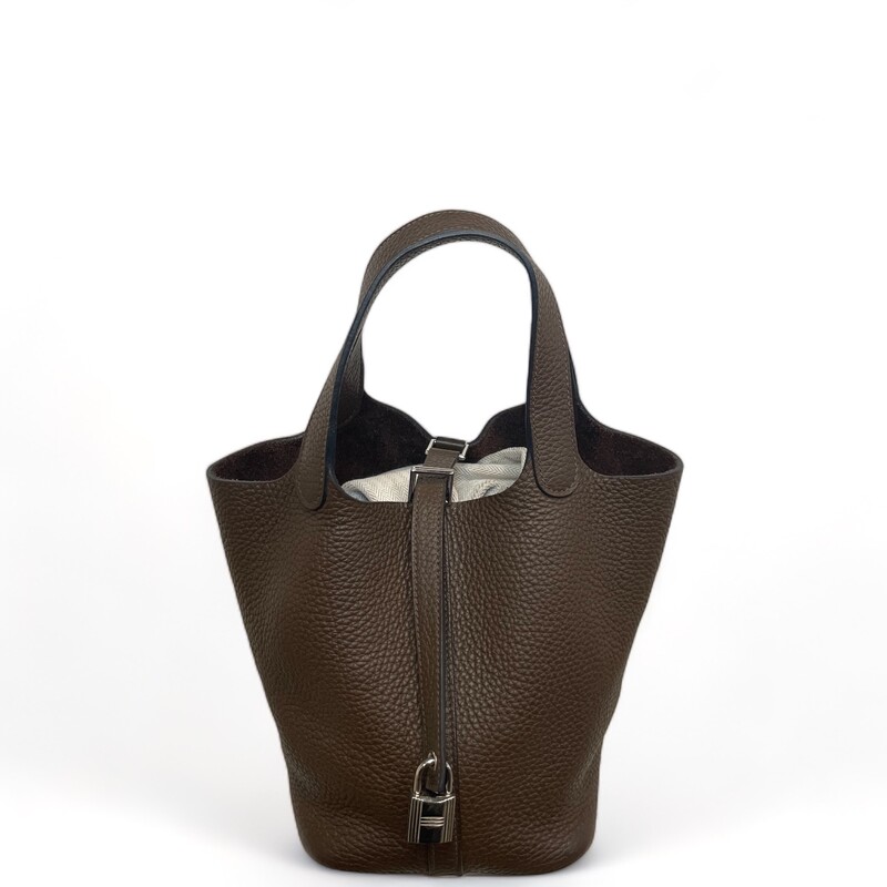 HERMES Taurillon Clemence Picotin Lock 18 PM in Cafe. This tote is crafted of soft taurillon clemence calfskin leather in brown. This  tote is a one piece handbag with top handles that extend from the sides with an extra layer of leather for support. The top is open to a spacious suede interior.

Dimensions:
7 width x 5 height x 7.5 depth; 5 handles