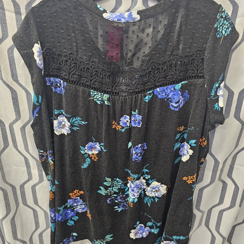 Black sleeveless floral printed knit top with lace style top.