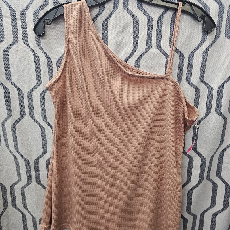 Fun tank with one spaghetti strap and one larger tank strap in a peach color.