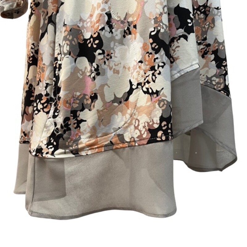 Logo Lounge Tunic<br />
Sheer Ruffle Detail<br />
Abstract Floral Design<br />
Color: Cream and Black<br />
Size:  Medium
