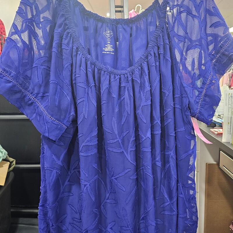 Short sleeve blouse in blue that can be dressed up or down. Sheer sleeve and over lay for a sewn in tank panel for coverage.