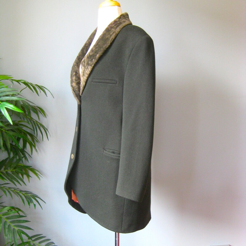 Cool long line blazer in deep gray green wool and cashmere blend with a faux fur collar.<br />
It was made in Belgium<br />
Single breasted with glossy round plastic buttons<br />
working welted pockets at the hip and one side of the chest<br />
Fully Lined with shoulder pads built in under the lining.<br />
It's a bit longer in the back that in the front.<br />
<br />
Flat Measurements:<br />
Armpit to Armpit: 20.5<br />
Shoulder to shoulder: 18.25<br />
Underarm seam: 16.5<br />
Length in front: 34, in back 37<br />
<br />
perfect condition<br />
thanks for looking!<br />
#68347