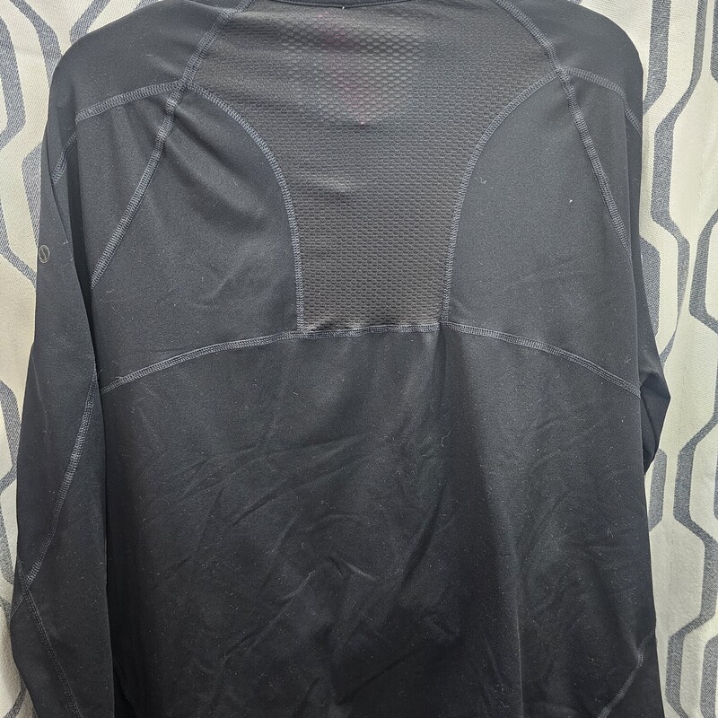 Zip up activewear jacket in black with thumb cut outs and a sheer mesh panel in the back.