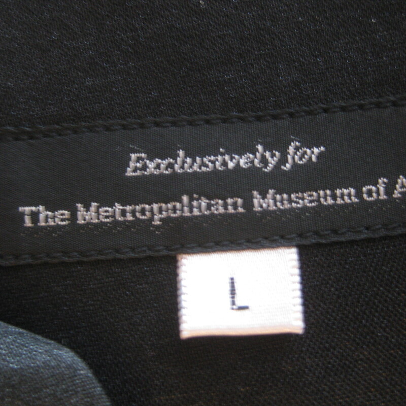 Pretty satin jacket from the Metropolitan Museum of Art shop.<br />
It's black with floral embroidery on the front, back and at the end of both sleeves.<br />
Red lining<br />
button closure<br />
marked size L<br />
flat measurements:<br />
shoulder to shoulder: 17.25<br />
armpit to armpit: 22<br />
length: 26<br />
underarm sleeve seam: 17<br />
<br />
excellent pre-owned condition, no flaws!<br />
<br />
thanks for looking!<br />
#69037