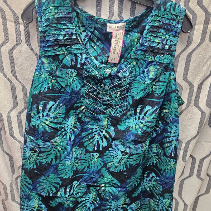 Sleeveless blouse in a black background with blue and green palm leave print and beaded front.