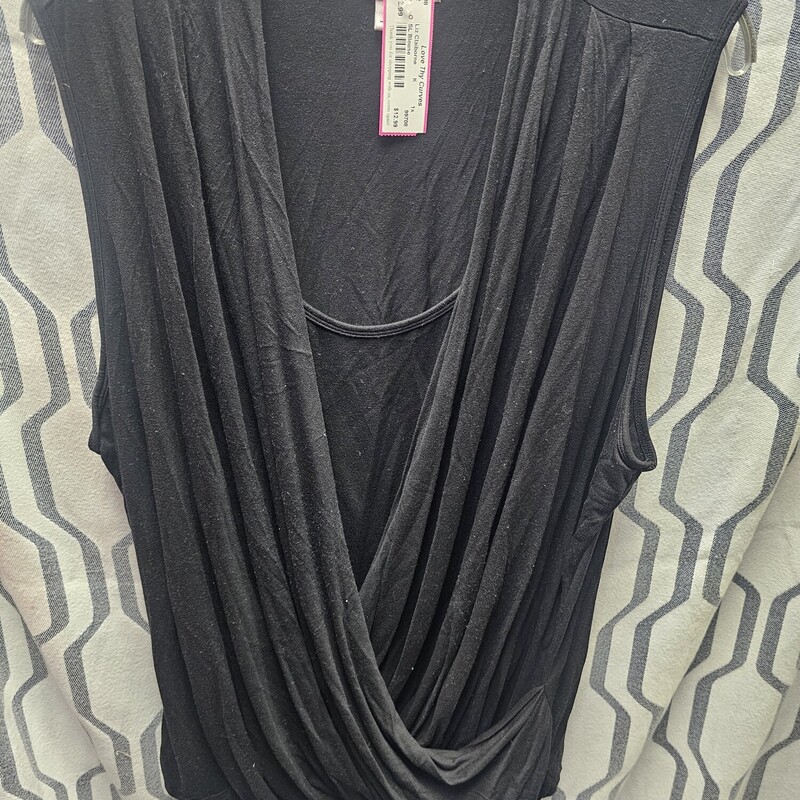 Twinset style sleeveless knit top in black. Wrap style top layer and a sewn  in front panel.